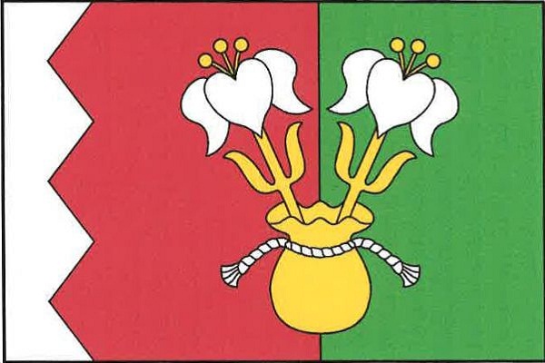 List tvoří tři svislé pruhy, bílý, pilovitý červený se třemi zuby sahajícími do první dvanáctiny délky listu a zelený, v poměru 2 : 5 : 5. Na styku červeného a zeleného pruhu vyrůstají ze žlutého váčku, převázaného bílou šňůrou, dvě odkloněné bílé přiroze