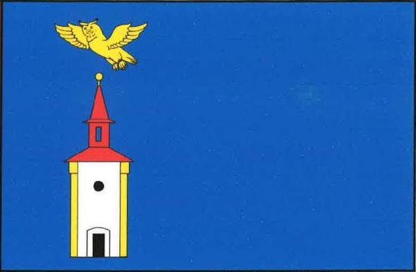 Modrý list, v žerďové polovině volná bílá zvonice se žlutými boky, s dveřmi a kruhovým oknem, obojí černé, se střechou a lucernou, obojí červené, a se žlutou makovicí. Nad věží letící žlutý výr. Poměr šířky k délce listu je 2 : 3.